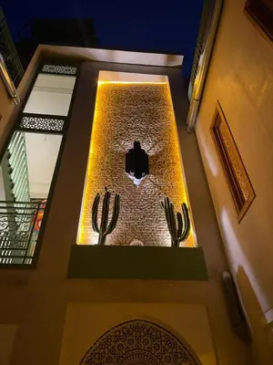 an overhead view of a staircase with cactuses in a building at Riad Casa Maria in Marrakech