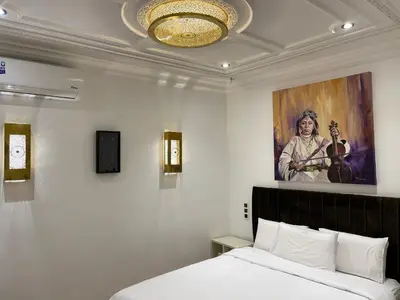 a bedroom with a bed and a painting on the wall at Riad Casa Maria in Marrakech