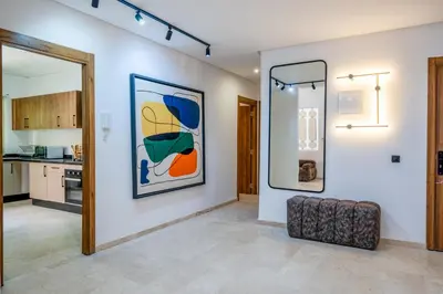 a living room with two framed paintings on the wall at Duplex 5 Chambres à Marrakech Luxe, Vue Piscine in Marrakech