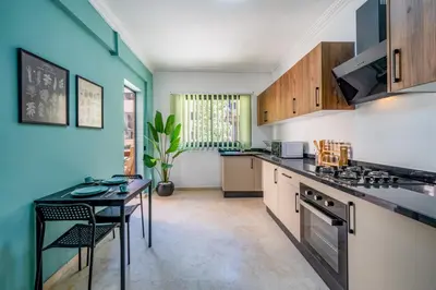 a kitchen with a table and a stove top oven at Duplex 5 Chambres à Marrakech Luxe, Vue Piscine in Marrakech
