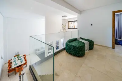 a living room with a glass table and a couch at Duplex 5 Chambres à Marrakech Luxe, Vue Piscine in Marrakech