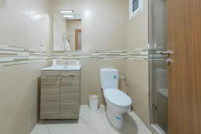 a bathroom with a toilet and a sink and a shower at Luxueux Appartement Avec piscine in Marrakech