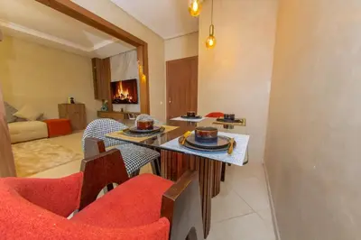 a living room with chairs and a table with food on it at Luxueux Appartement Avec piscine in Marrakech