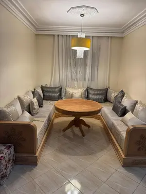 a living room with a table and a couch at A bright and airy living room in Marrakech