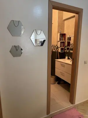 a room with a bathroom with a sink and a mirror at A bright and airy living room in Marrakech