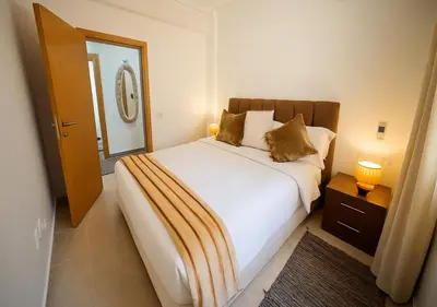 a bedroom with a white bed and a mirror at Gate 3 in Marrakech
