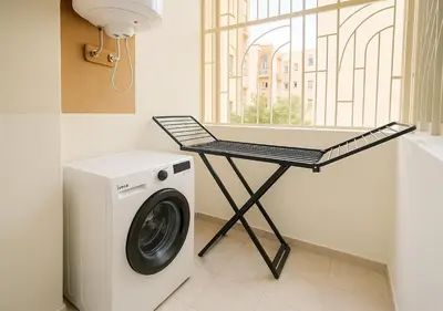 a laundry room with a washing machine and a table at Gate 3 in Marrakech