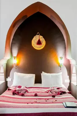 a bedroom with a large bed with a wall at Riad LOU, 5 bedrooms, private 12 p, pool, hammam in Marrakech