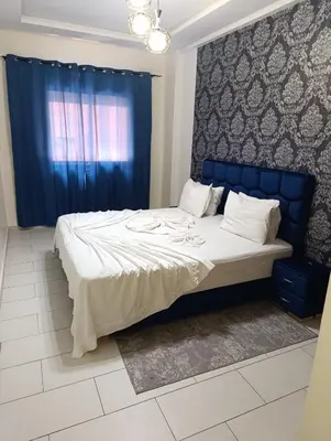 a bedroom with a large bed with a blue headboard at Magnifique studio douillet in Marrakech