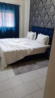 a bed in a bedroom with a blue headboard at Magnifique studio douillet in Marrakech