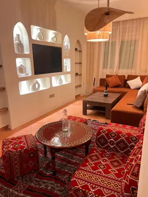 a living room with a couch and a table at Riad Appart F3 Exceptionnel à Guéliz - À 5 min de la gare - Piscine, Wi-Fi et parking au cœur de Marrakech in Marrakech