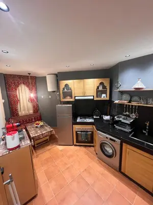 a kitchen with a stove and a counter top at Riad Appart F3 Exceptionnel à Guéliz - À 5 min de la gare - Piscine, Wi-Fi et parking au cœur de Marrakech in Marrakech