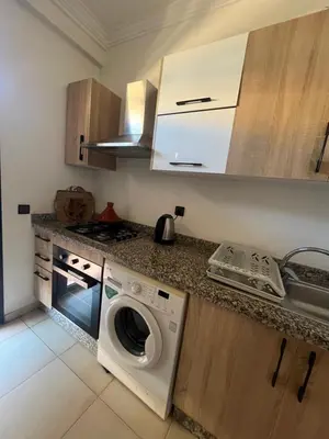 a kitchen with a washing machine and a sink at Nor in Marrakech