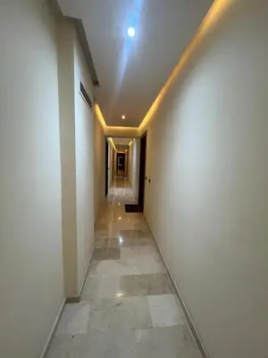 an empty hallway with a white wall and a tile floor at Nor in Marrakech