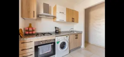 a kitchen with a washing machine and a washer at Nor in Marrakech