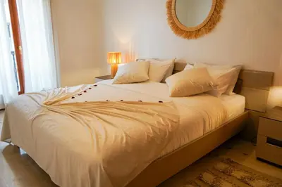 a bedroom with a large white bed with a mirror at Plaza Julianah in Marrakech