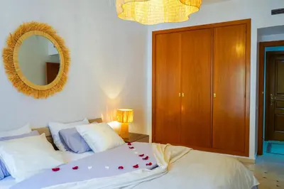 a bedroom with a bed with a mirror on the wall at Plaza Julianah in Marrakech