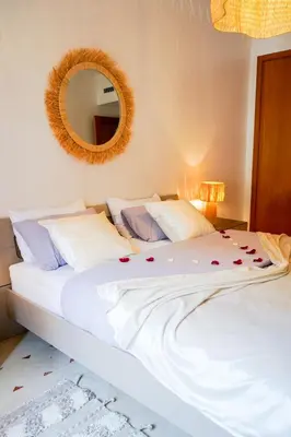 a bedroom with a white bed with roses on it at Plaza Julianah in Marrakech