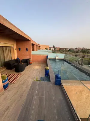 a patio with a swimming pool on top of a building at Apartement in Marrakech Village Prestigia - 2 Bedrooms - private pool in Marrakech