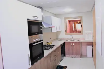 a small kitchen with a stove and a sink at Apartement in Marrakech Village Prestigia - 2 Bedrooms - private pool in Marrakech