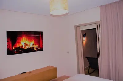 a bedroom with a fireplace on the wall at Apartement in Marrakech Village Prestigia - 2 Bedrooms - private pool in Marrakech
