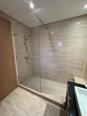 a shower with a glass door in a bathroom at Apartement in Marrakech Village Prestigia - 2 Bedrooms - private pool in Marrakech