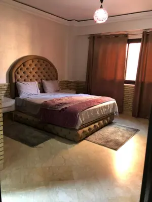 a bedroom with a large bed with a large headboard at - Résidence Babylone Y - 3 Bedrooms Appartement in Marrakech