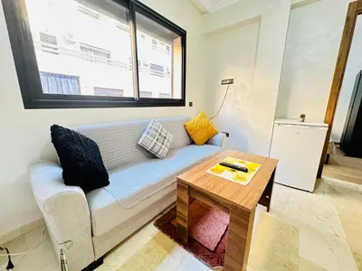 a living room with a couch and a table at Gueliz flat centre in Marrakech