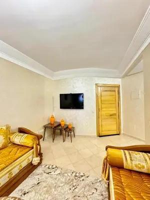 a living room with a couch and a tv at spacieux appart familial avec 2 chambres in Marrakech