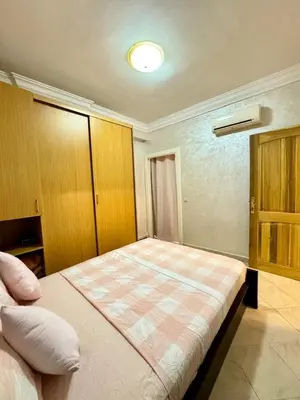 a bedroom with a large bed in a room at spacieux appart familial avec 2 chambres in Marrakech
