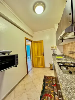 a kitchen with a stove and a counter top at spacieux appart familial avec 2 chambres in Marrakech