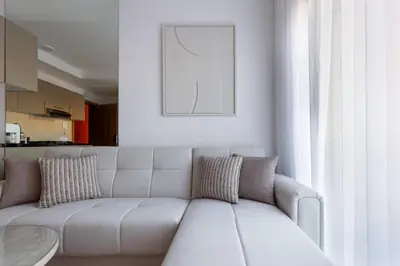 a living room with a white couch and a table at Escapade relaxante au Domaine NORIA in Marrakech