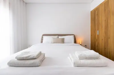 a bedroom with a white bed with two towels on it at Escapade relaxante au Domaine NORIA in Marrakech
