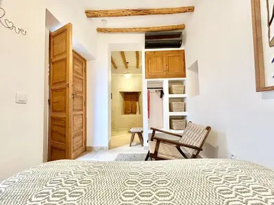 a bedroom with a bed and a chair in a room at Riad Fleur de Kasbah in Marrakech