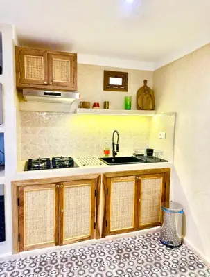 a kitchen with a sink and a stove at Riad Fleur de Kasbah in Marrakech