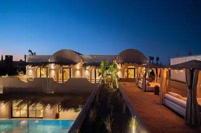 a house with a swimming pool at night at Villa Bali Amelkis in Marrakech