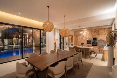 a dining room with a large wooden table and chairs at Villa Bali Amelkis in Marrakech