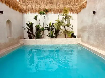 a swimming pool with plants in a building at Riad Casa Léa - Bassin chauffé - Petits déjeuners in Marrakech