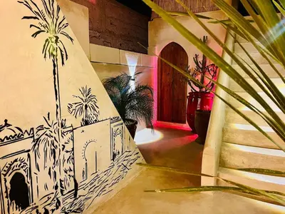 a stairway with a painting on the side of a building at Riad Casa Léa - Bassin chauffé - Petits déjeuners in Marrakech