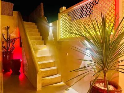 a staircase with a potted plant in a room at Riad Casa Léa - Bassin chauffé - Petits déjeuners in Marrakech