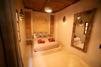 a bedroom with a bed and a large mirror at Riad Casa Léa - Bassin chauffé - Petits déjeuners in Marrakech