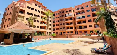 a swimming pool in front of some tall buildings at - Résidence Babylone Y - Appartement 3 Chambres in Marrakech