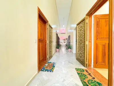 a hallway with wooden doors and rugs on the floor at Elegant 2-Bedroom Duplex Downtown Private Terrace in Marrakech