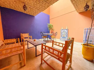 a room with chairs and a table and a table and chairs at Elegant 2-Bedroom Duplex Downtown Private Terrace in Marrakech
