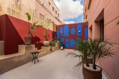 a courtyard with potted plants in a building at Évasion aux portes de Majorelle in Marrakech