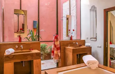 a bathroom with two sinks and a large mirror at Villa Jardin Nomade in Marrakech