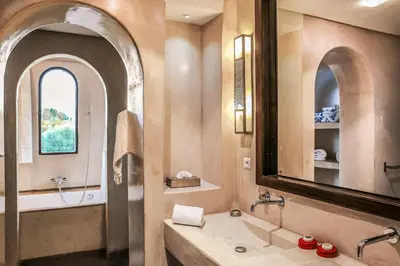 a bathroom with a large mirror and a sink at Villa Jardin Nomade in Marrakech