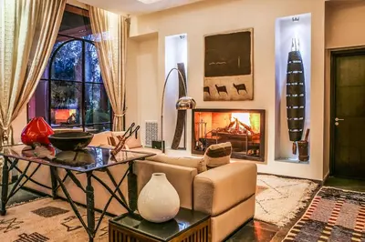 a living room with a couch and a fireplace at Villa Jardin Nomade in Marrakech