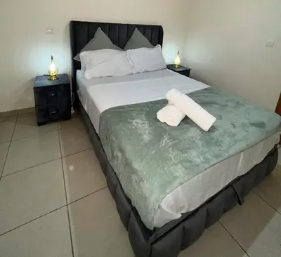 a bed with two rolls of toilet paper on it at Darraha- Ideal for early & Late flights-Near Marrakech airport 10 min- menara Garden 5 min-Transport support in Marrakech