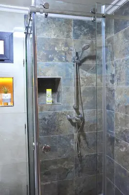 a shower with a glass door in a bathroom at Darraha- Ideal for early & Late flights-Near Marrakech airport 10 min- menara Garden 5 min-Transport support in Marrakech